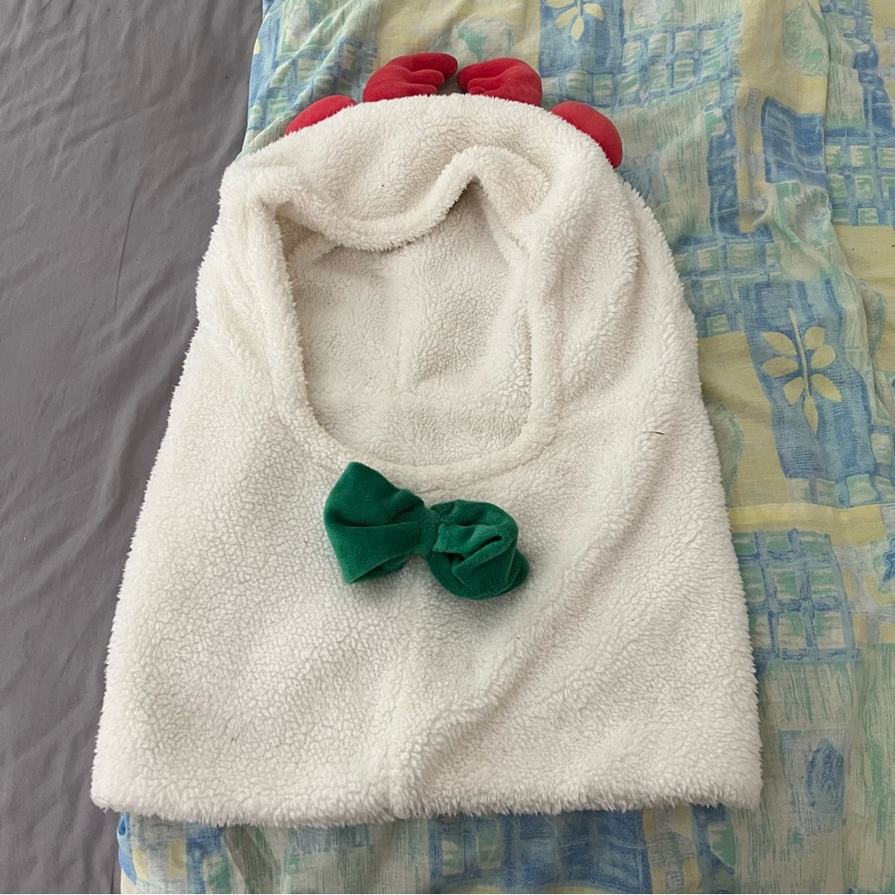 Fuzzy white hood with red antlers and green bow